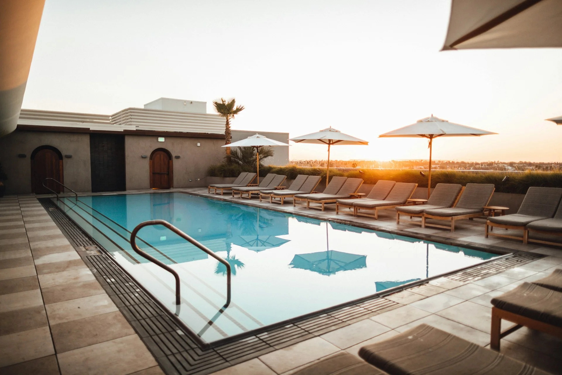 Blue outdoor swimming pool and pale stone terrace